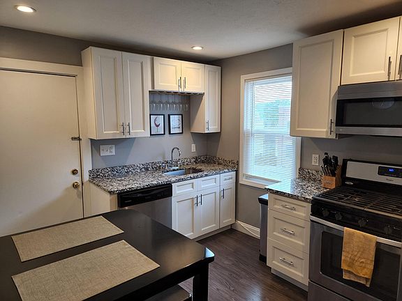 Newer kitchen with high end white shaker cabinets and granite countertop. Newer stainless steel
