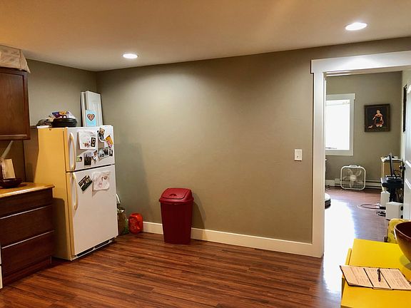 Large kitchen area with stackable washer/dryer.