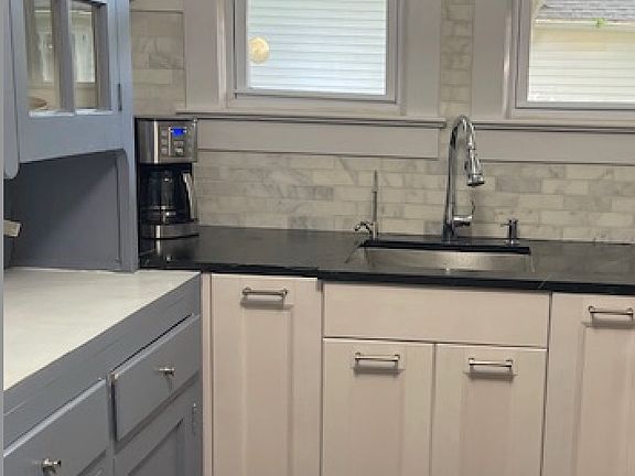 Carrara backsplash, built-into the soapstone counter is the dish soap dispenser and water filter.