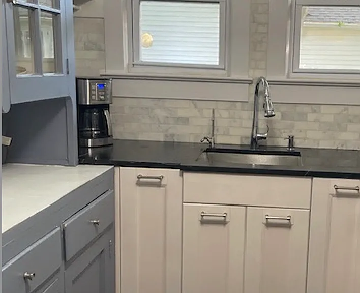 Carrara backsplash, built-into the soapstone counter is the dish soap dispenser and water filter.