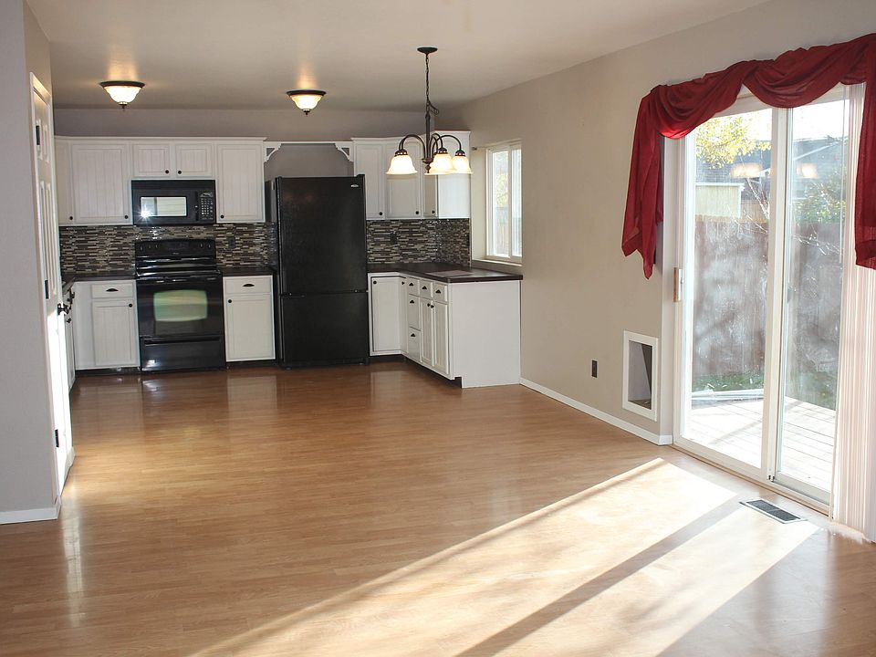 Sunny open concept kitchen/dining/living area. Patio doors and doggie door open to trex back deck and fully fenced yard.