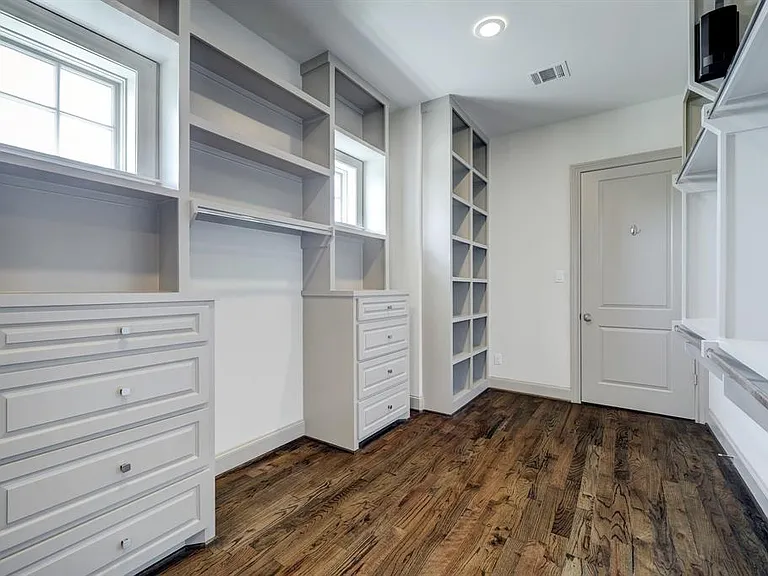 The oversized primary closet offers amazing hanging space, custom built-in shelves and drawers, and is a great feature of this home.