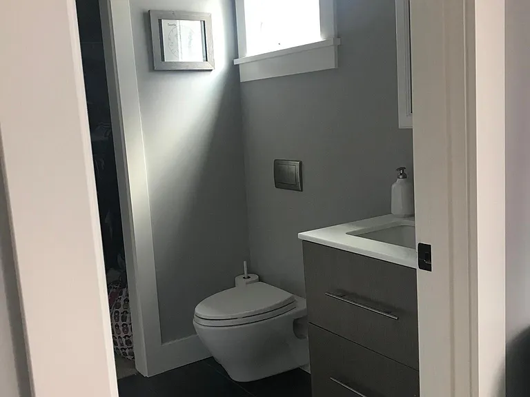 Main floor bedroom ensuite bathroom with heated towel rail and large closet