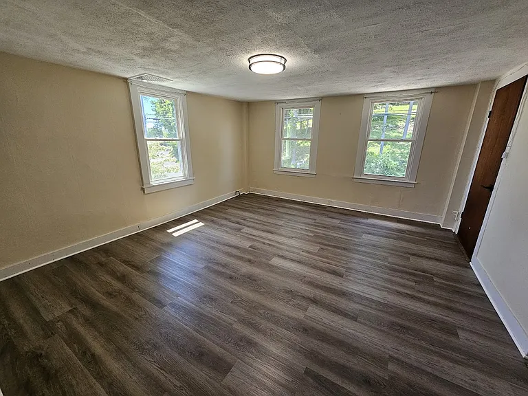 Actual image of primary bedroom with new flooring.