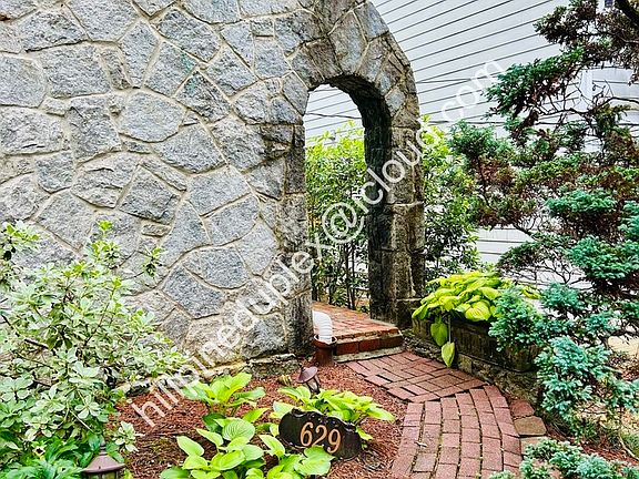 Private entrance with walkway from parking pad.