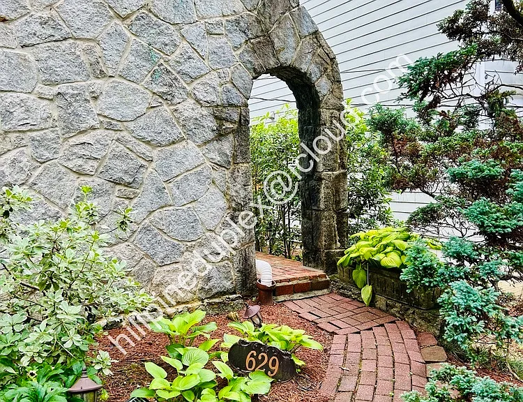 Private entrance with walkway from parking pad.