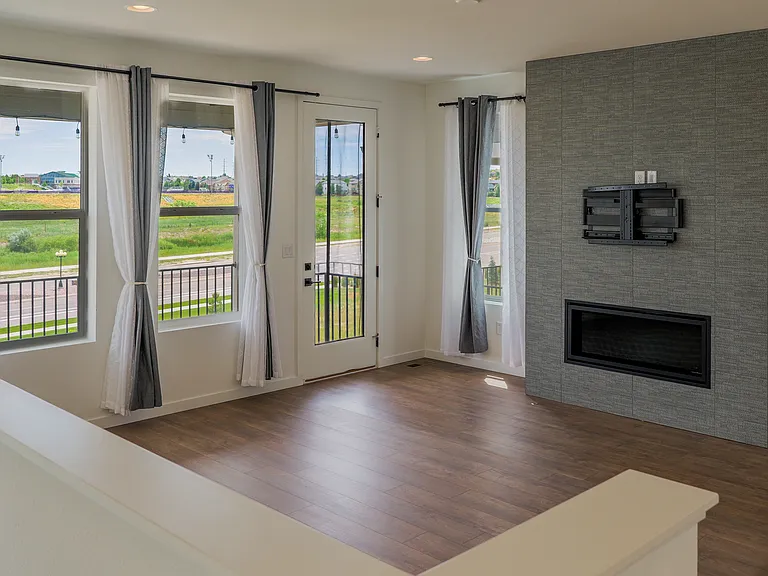 Comfortable living room featuring a central fireplace and natural light