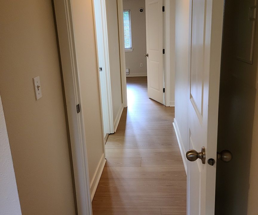 Hallway with bedrooms on either end and bathroom/laundry room in between