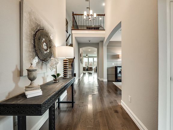 Entryway into foyer with two-story ceilings