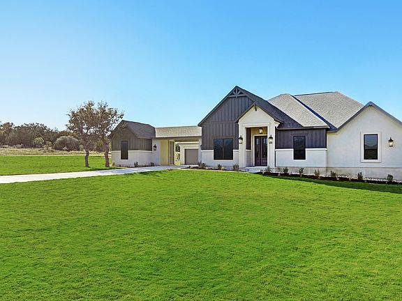 This home offers incredible curb appeal with a porte cochere and courtyard.