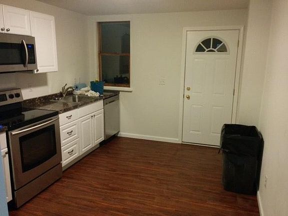 Backdoor leading out to shared gated patio w/ keyed access t