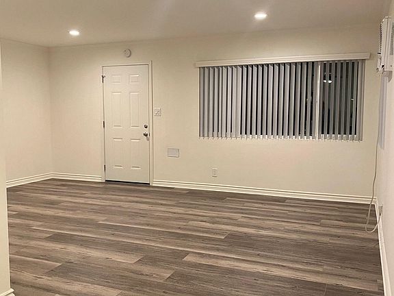 spacious living room wood like flooring throughout