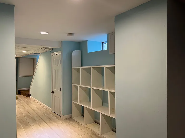Cubbies for storage near large closet for storage. Entrance to apartment is at end of the hallway on the right leading out to driveway.