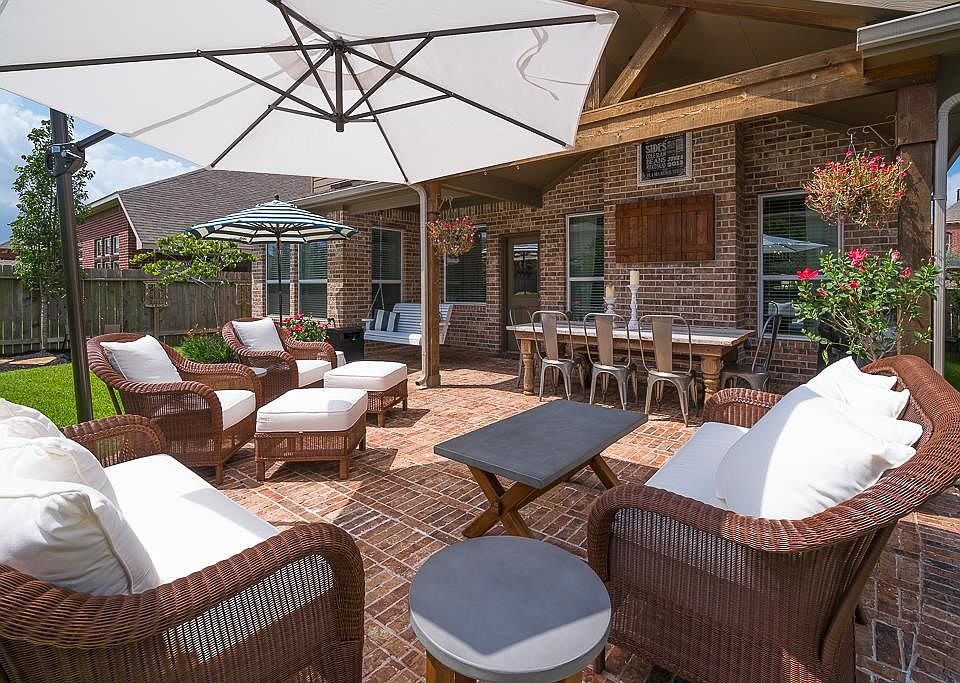 Beautiful backyard retreat with extended brick patio, cedar gabled covered patio with custom wood tv mount.  Professionally hung patio swing to enjoy the sweet jasmine fragrance and take in the beautiful landscape with three maple trees.