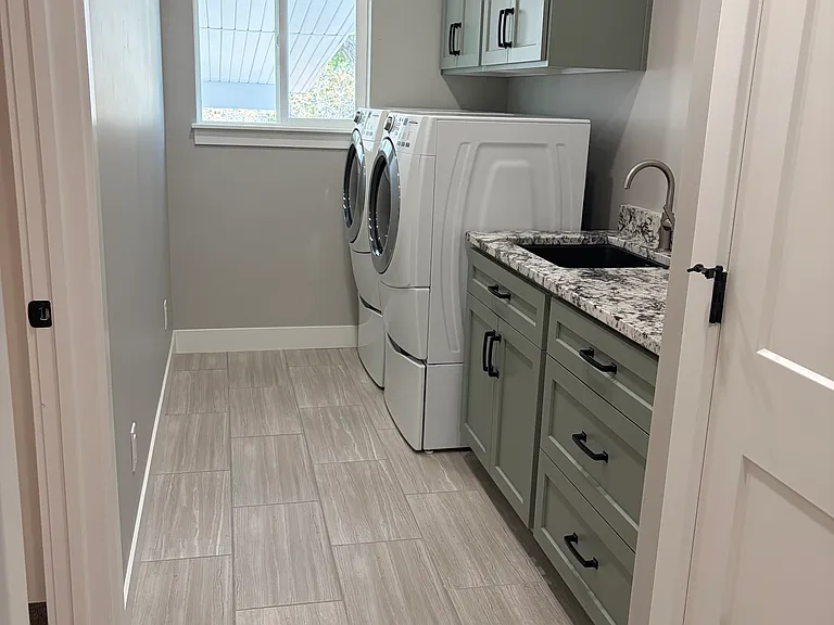 Laundry room. Includes a lot of storage and laundry drying rack.