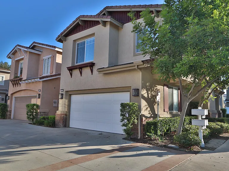 Attached two car garage with overhead storage system and lots of shelving.