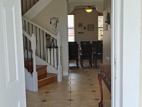 Entry with Front Room to the left, laundry and downstairs ba