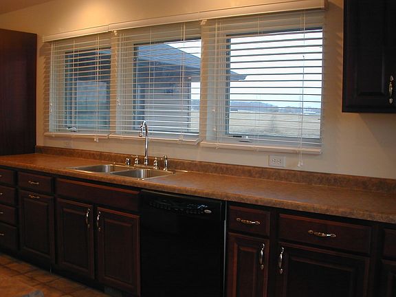 Kitchen sink, dishwasher, refrigerator, (3) 36" windows. No