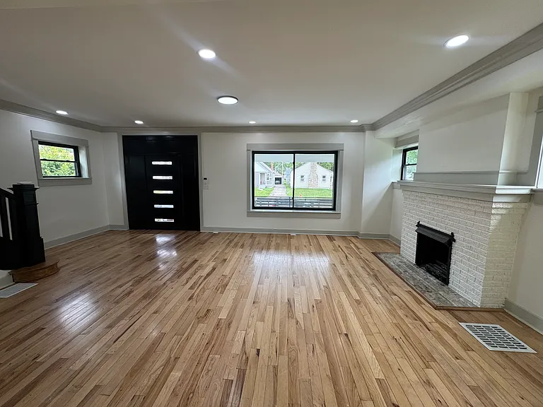 Big, sunny iving room w/ charming fireplace & mantle!