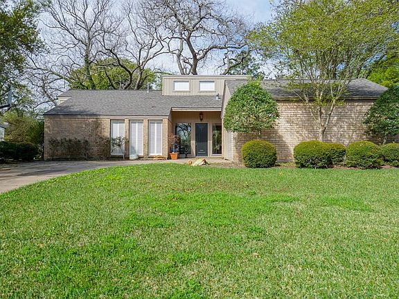 Mature landscaping and gorgeous trees frame this fantastic home