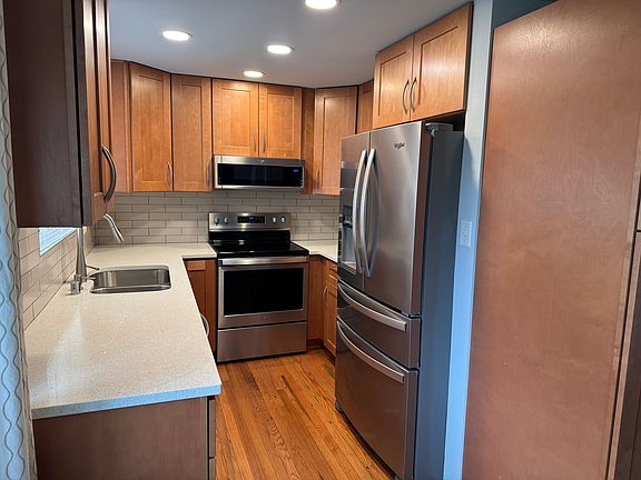 This galley-style kitchen is hard to capture in a photo. It is a very efficient layout with a lot of work space and storage space. The pantry is shown to the right of the fridge.