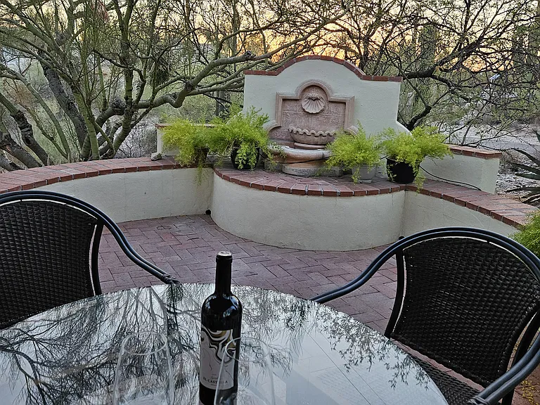 Relax on the back patio and watch the sun set. Covered patio with ceiling fan for summer comfort.