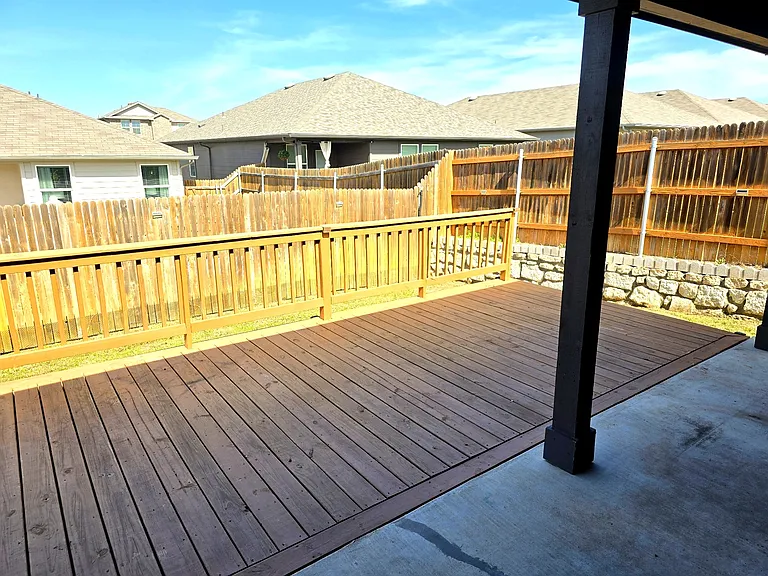 Relaxing covered patio overlooking private fenced yard.