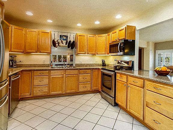 large, open kitchen with granite countertops and stainless appliances