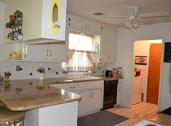 Beautiful natural light pours in the kitchen! Concrete counter tops installed in 2015. Laundry room leads out to the garage.