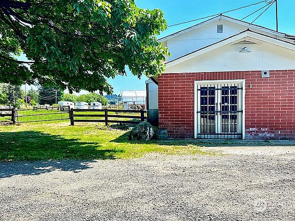 Office, warehouse and shop. Parking lot w/ fenced gate is to the left of the building.>