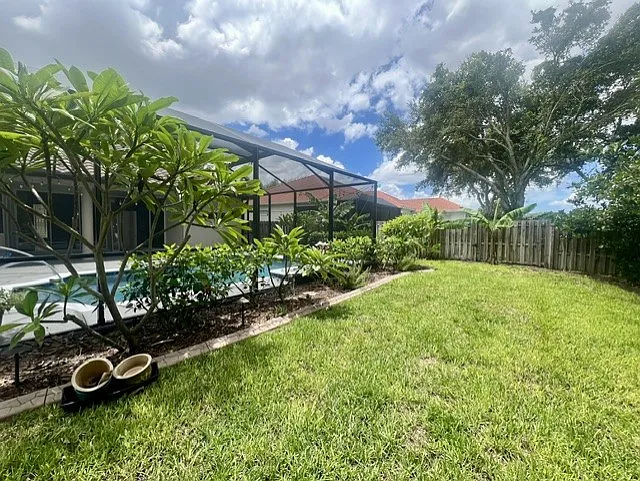 Beautiful back yard with great afternoon and evening shade. Sit in the screened lanai and have amazing sunset views to the West.