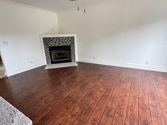 Wood flooring in den. gas logs in fireplace