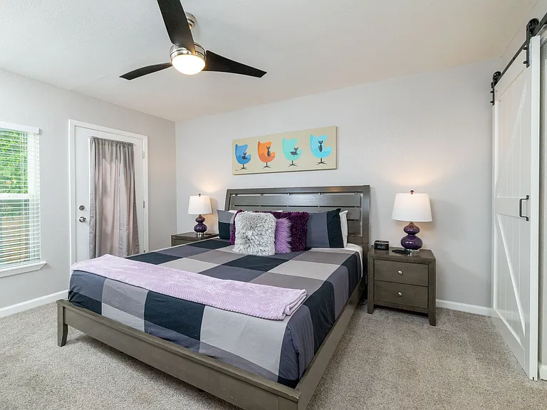 Bedroom 2 with king bed and door to patio with attached bathroom.