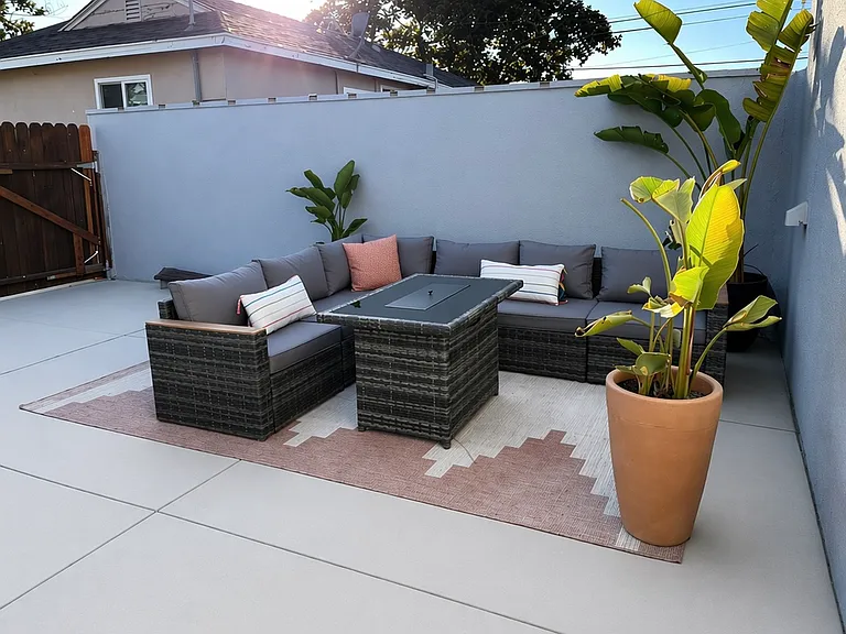 Second outdoor living area with modular seating and fire pit, perfect for entertaining.