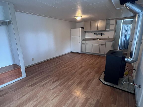 Living space with closet and stove.