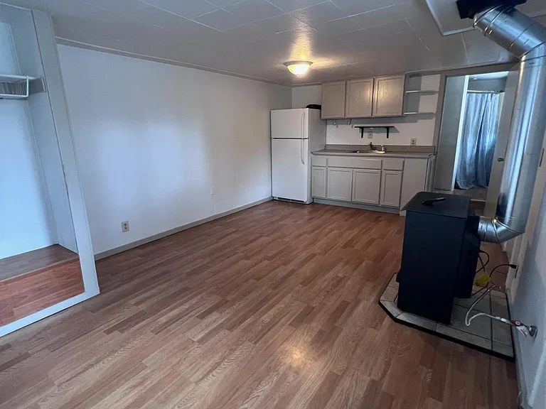 Living space with closet and stove.