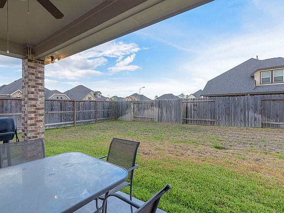 The covered patio looks out over the large backyard.