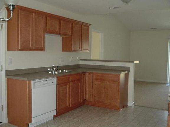 DISHWASHER & SINK (view to living room with bar height counter)