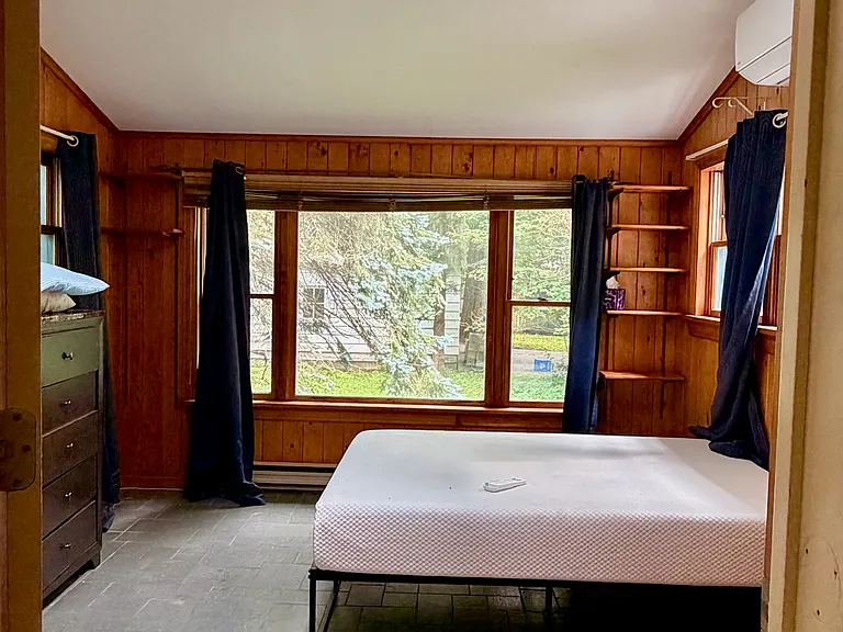 Rear garden bedroom, with heat pump at right. Not visible: private entry to left, closets at left & right.