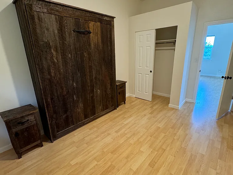 secondary bedroom with a closet. Fits a queen size bed. (pictured is a wall bed)