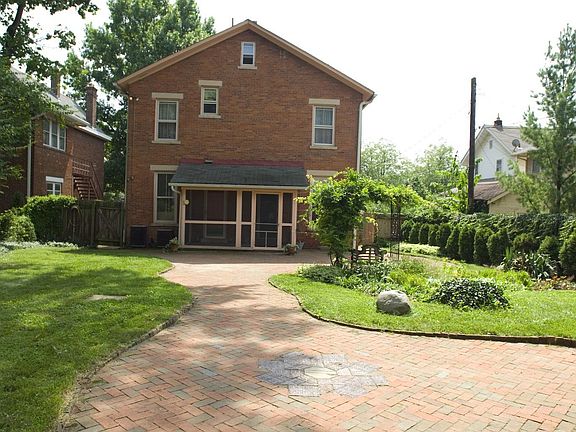Back of home with screened in porch