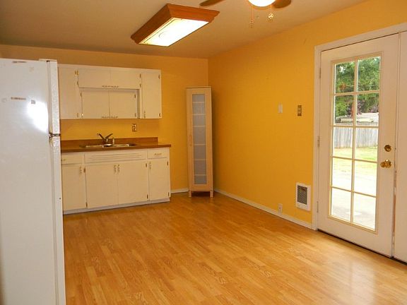 The kitchen has French doors to a large concrete patio behind the house.