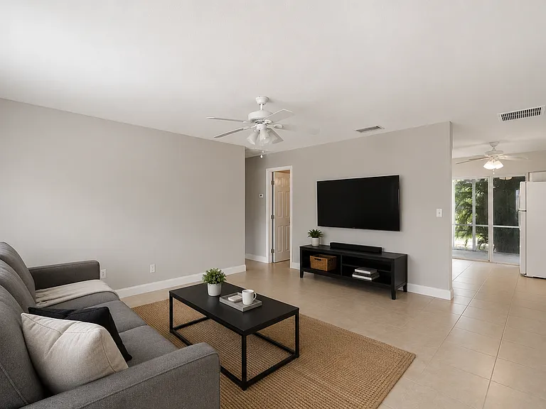 The living room boasts an open-concept design with luxury vinyl plank flooring, plenty of natural light, and seamless flow into the kitchen and dining areas. *Furniture not included*