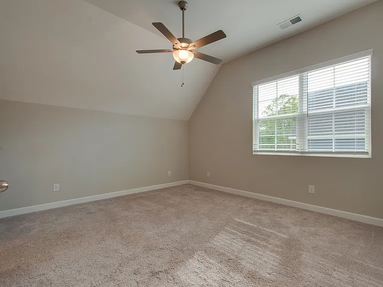 Primary bedroom is large enough for a king size bed and has a vaulted ceiling.