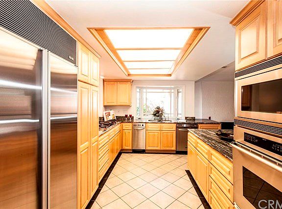 Subzero fridge, Dacor Electric wall oven and microwave, 5 burner gas stove top, trash compactor, dishwasher.