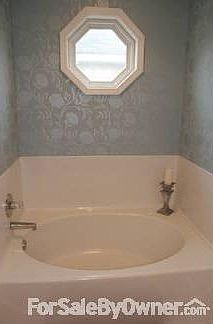 Master bath : Features a double vanity, garden tub, and a separate shower.