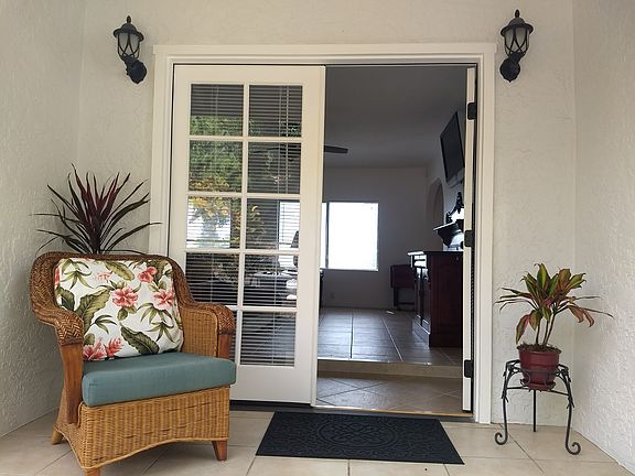Entryway from driveway on mauka (mountain side) of house. One step up into the living room.