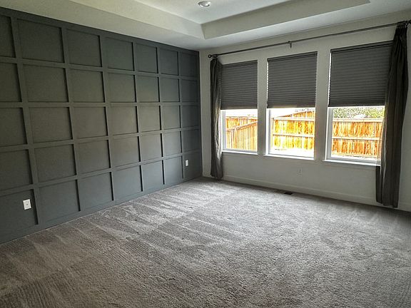 Bedroom with board and batten walls and hunter douglas blinds
