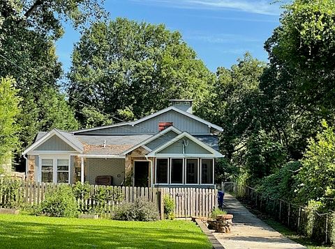 View of front unit with covered porch, screened patio and fenced front yard.