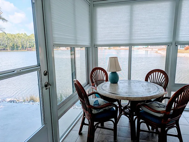 Lanai with shades half down and exit to left patio